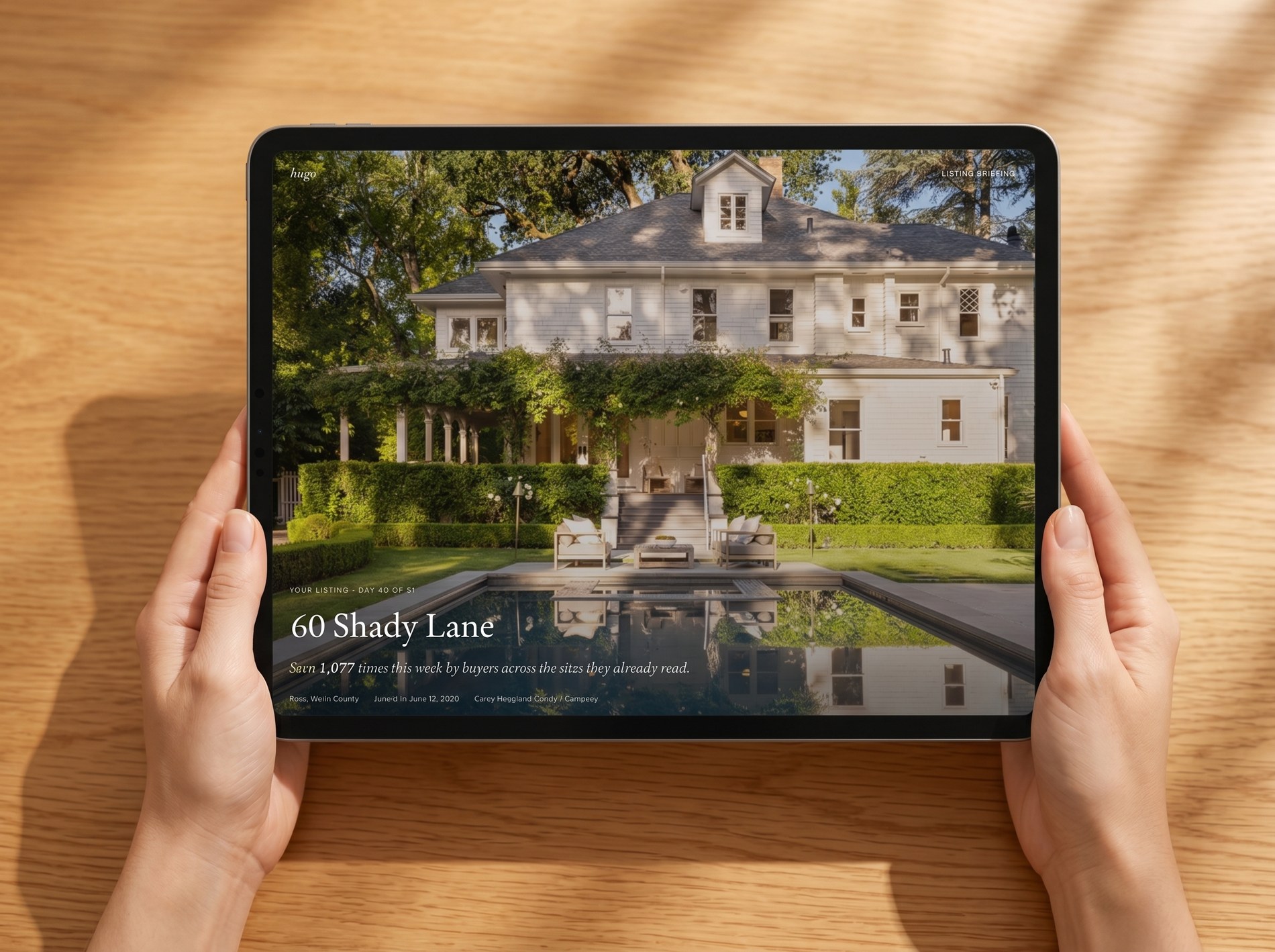 A real hugo listing running: a Ross estate at 60 Shady Lane, out on the sites buyers already read, shown on a tablet held in two hands